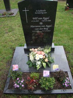 Graf met diverse bloemstukken en plantjes